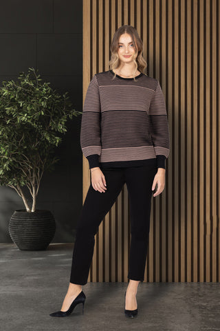 Woman wearing striped two-tone sweater with crew neckline and long sleeves