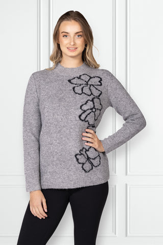 soft knit sweater with floral design detail along the side